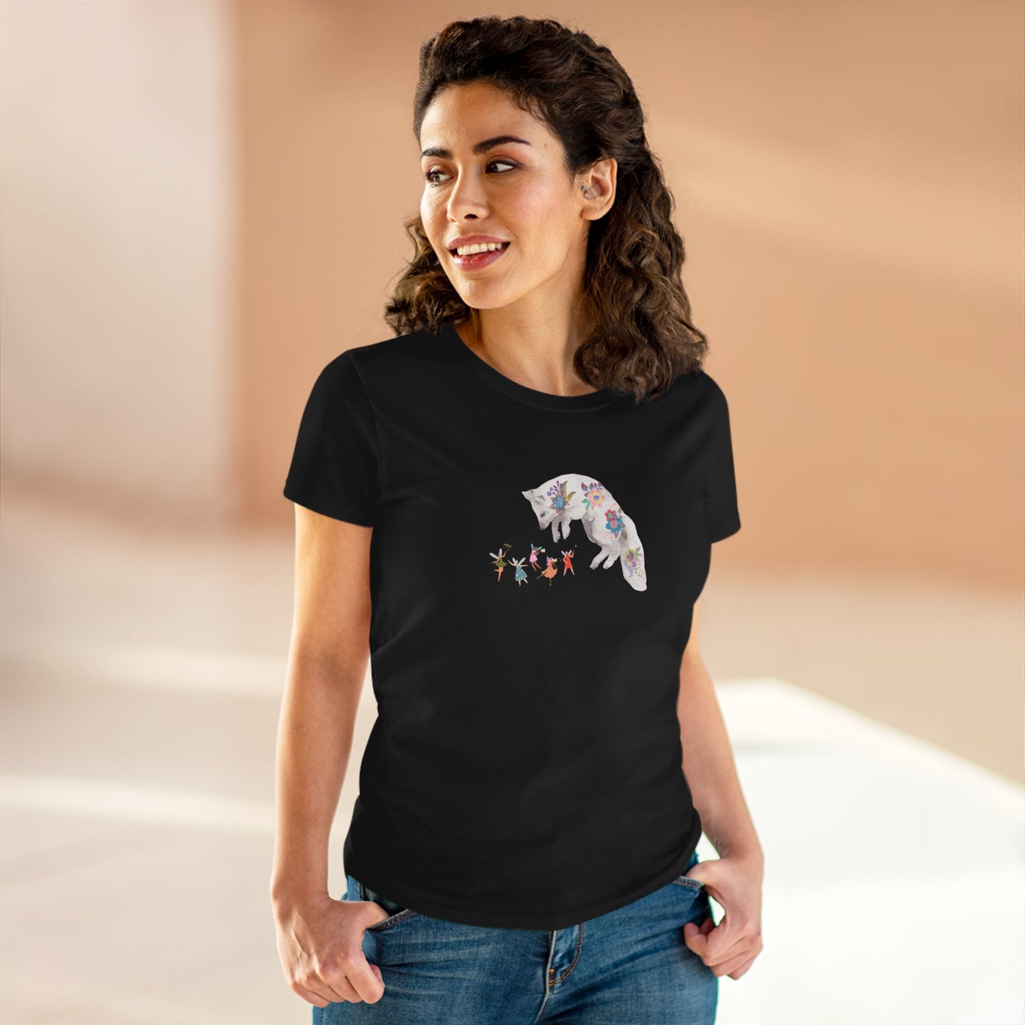 Woman wearing a black t-shirt with a graphic design on a beige background