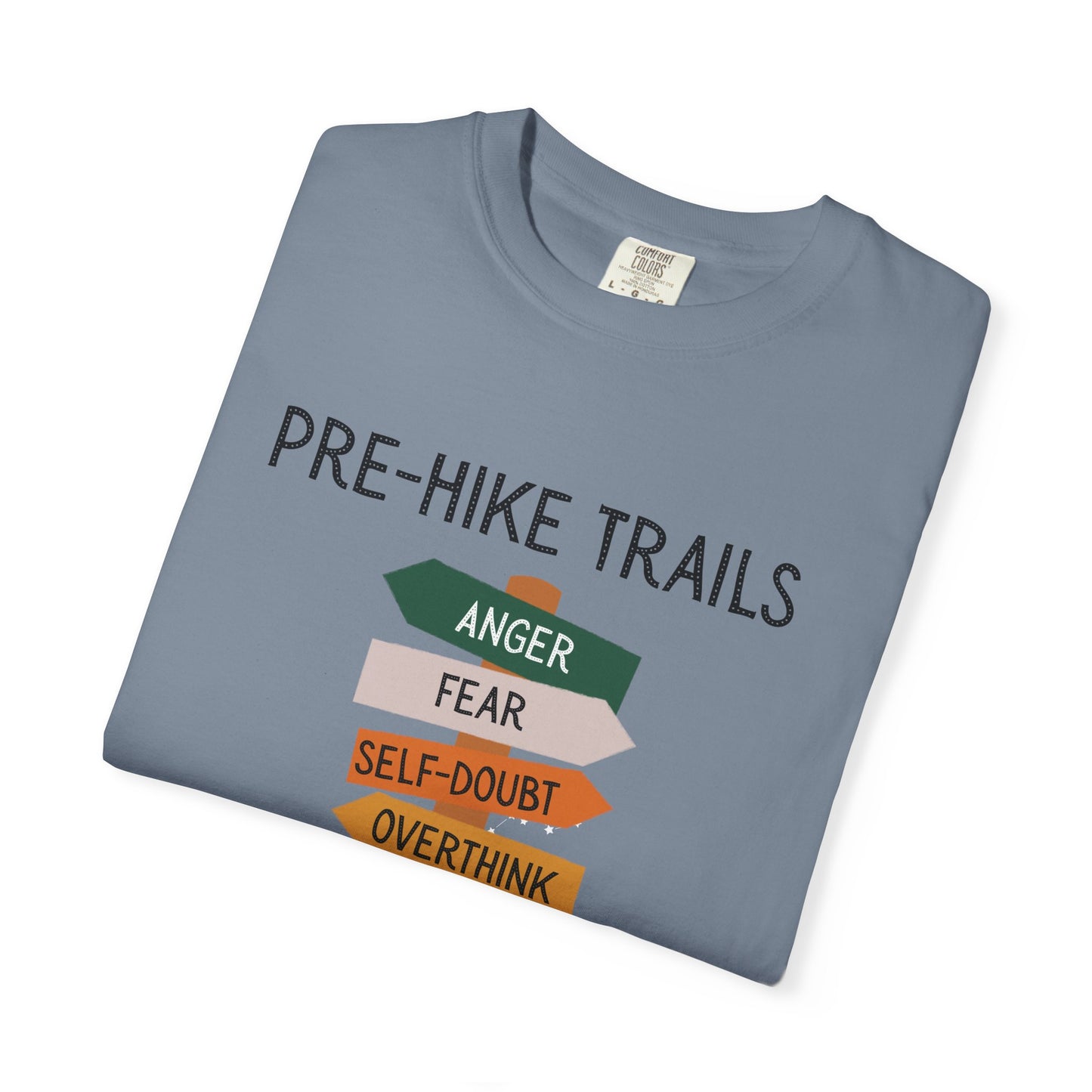 Folded blue t-shirt with 'Pre-Hike Trails' text and motivational phrases on a white background