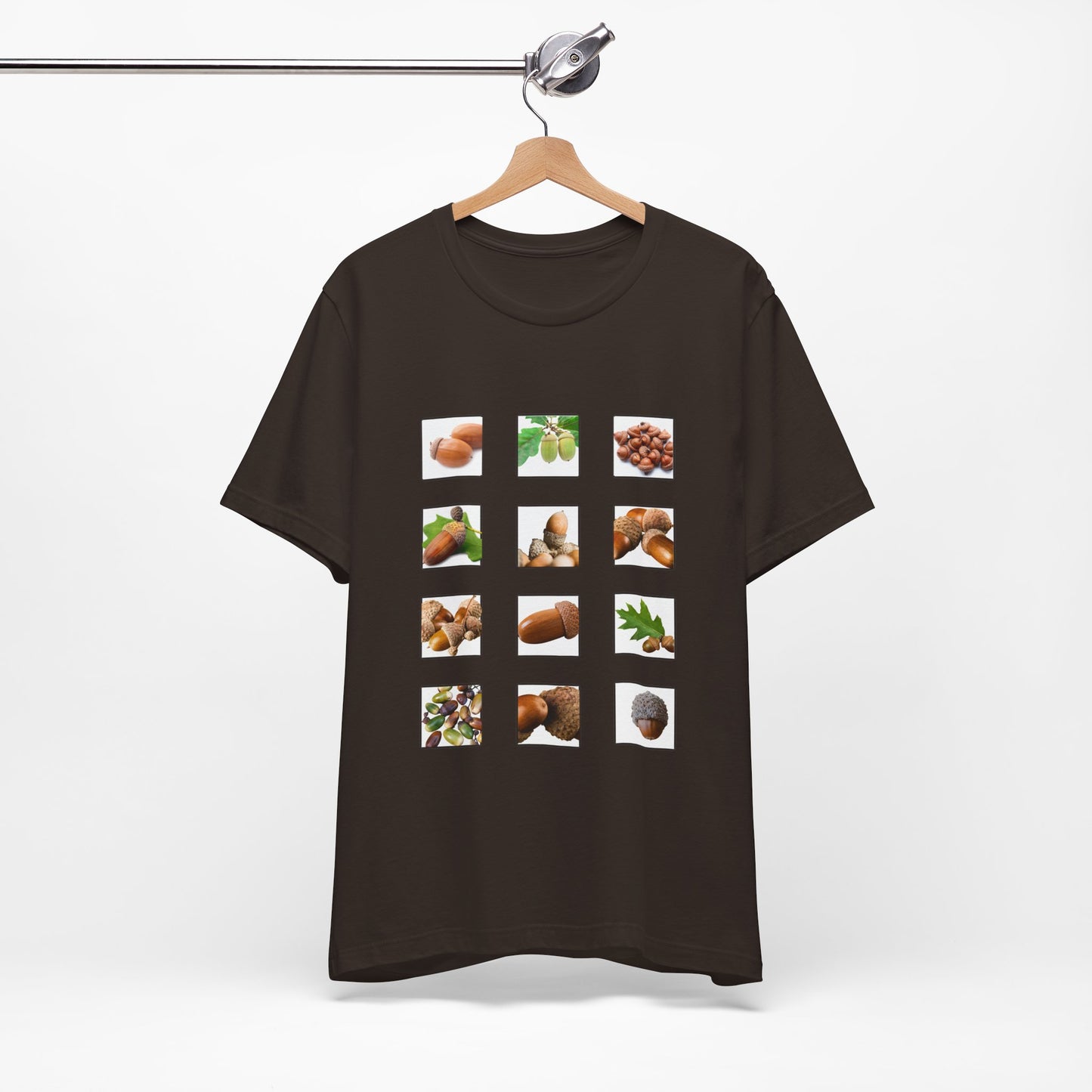 Brown t-shirt with postage stamp images of acorns items on a hanger against a white background
