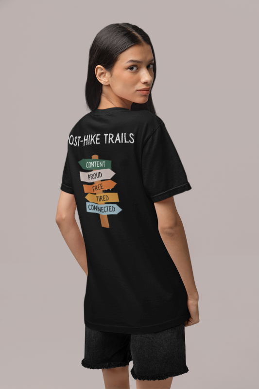 Person wearing a black t-shirt with text on the back against a gray background