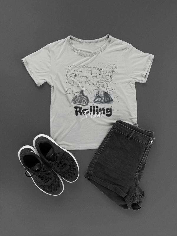 Gray t-shirt with graphic design, black shoes, and dark jeans on a gray background