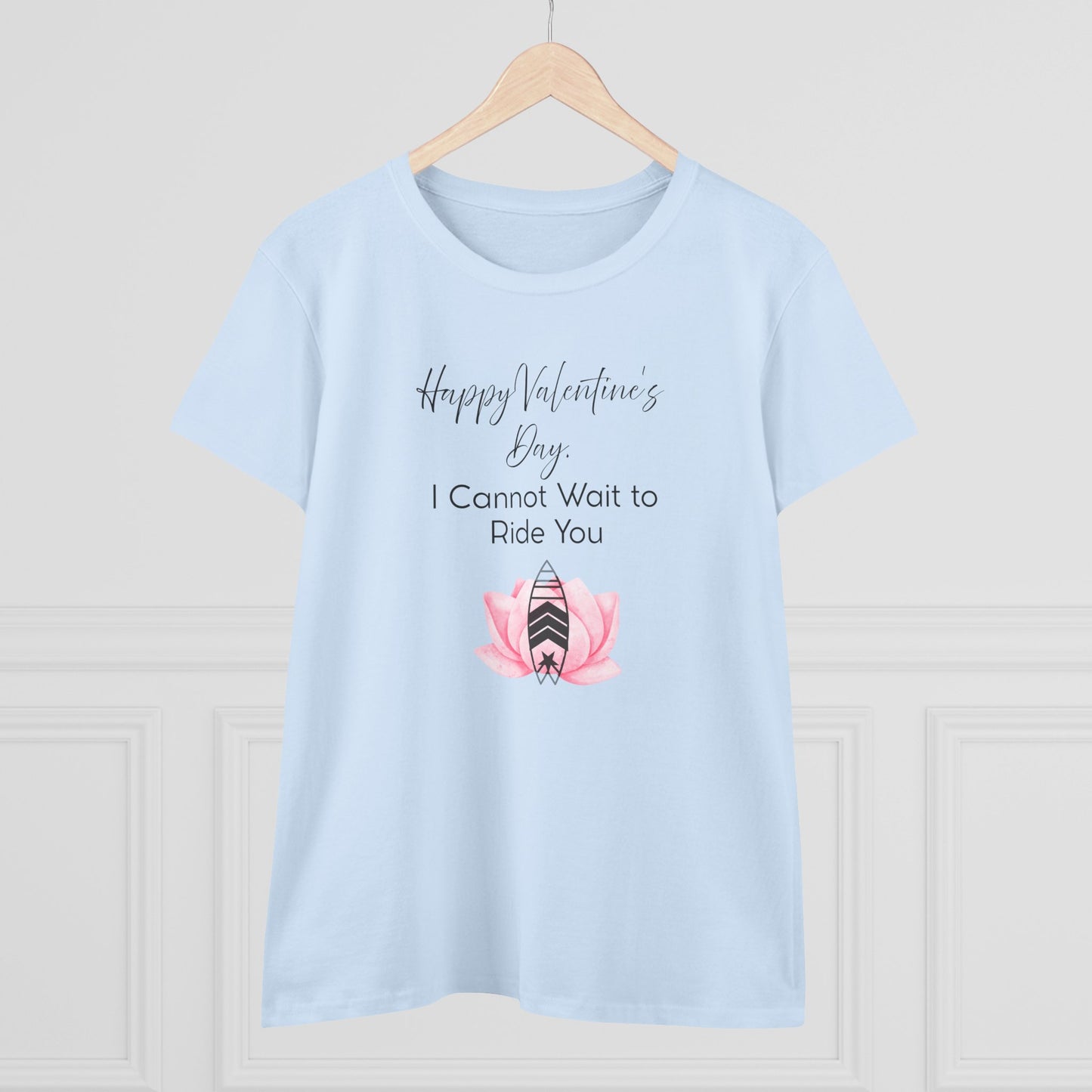 Light blue t-shirt with Valentine's Day design on a wooden hanger against a light gray background