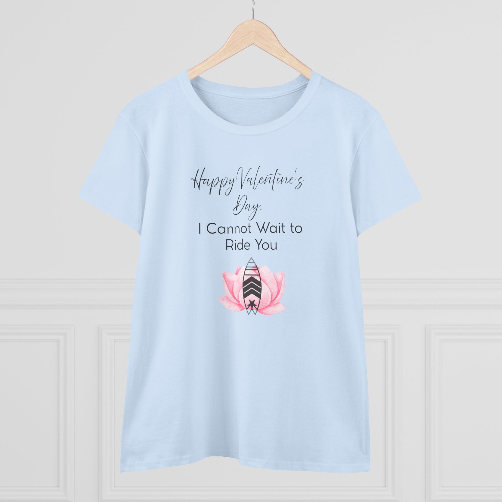 Light blue t-shirt with Valentine's Day design on a wooden hanger against a light gray background