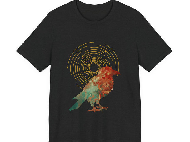 Raven dreamcatcher boho graphic with golden celestial rings and teal textured artwork on a black t-shirt.