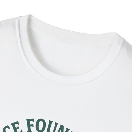 Close-up of a tag-less white shirt with green text on a white background
