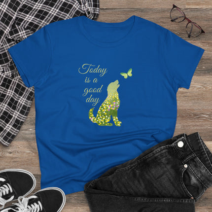 Blue t-shirt with a green dog and butterfly graphic and 'Today is a good day' text on a wooden surface with casual items.
