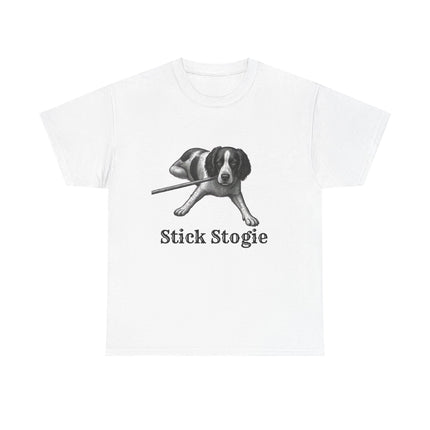 A white short-sleeve crewneck t-shirt featuring a black and white graphic of a dog proudly chewing a stick, with the text 'Stick Stogie' printed below in a serif font.