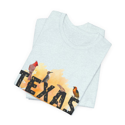 Light blue t-shirt, folded, with 'Texas' and bird design on a white background