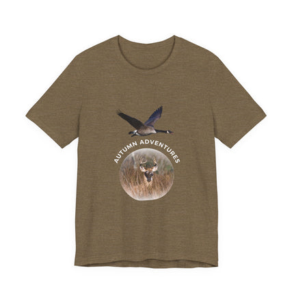 A heathered brown short-sleeve t-shirt with a graphic on the chest showing a flying goose and a deer head inside a circular frame with the text 'AUTUMN ADVENTURES'.