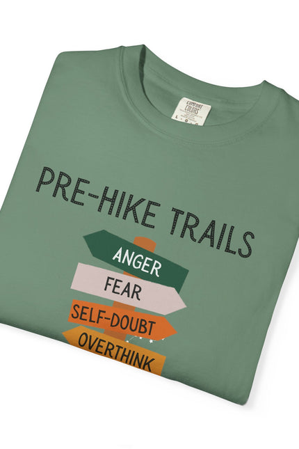 Folded green t-shirt with humorous text design on a white background