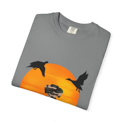 Folded gray t-shirt with a graphic of a sunset and birds on an orange background.