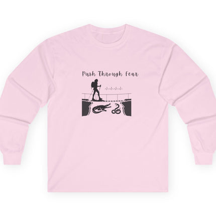 Light Pink long sleeved tee with black graphic showing hiker going over bridge with alligator and snake. Text states "Push through Fear."