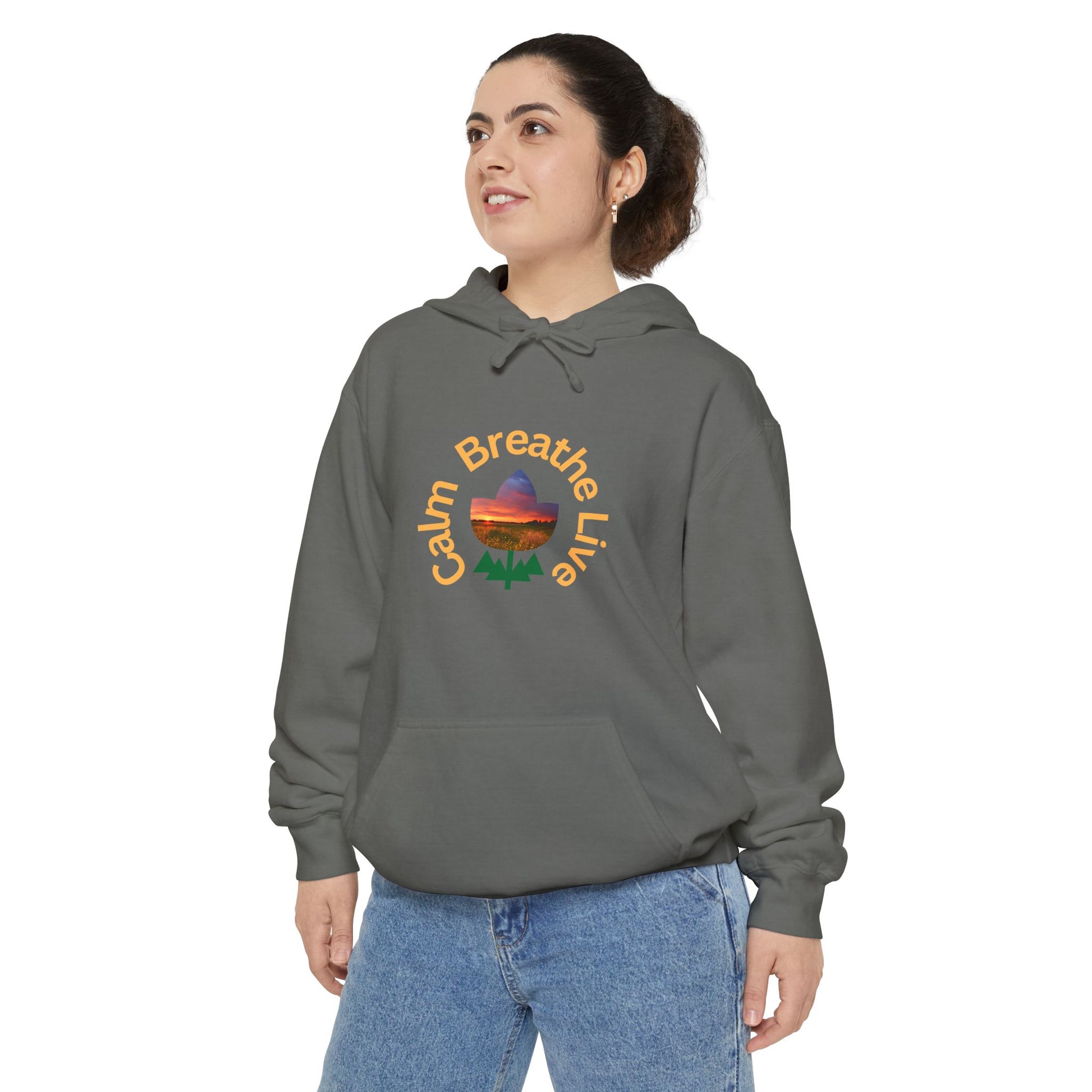 Person wearing a gray hoodie with a colorful graphic and text on a white background