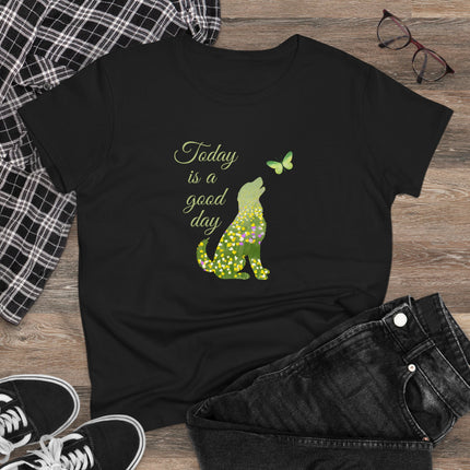 Black t-shirt with green dog and butterfly graphic and 'Today is a good day' text on a wooden surface with jeans and sneakers.