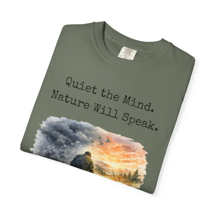 Folded green t-shirt with nature-themed design and text on a white background