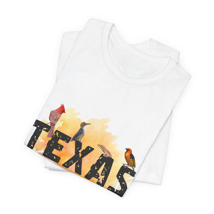 Stack of folded white t-shirt with TEXAS printed and birds sitting on top of words.