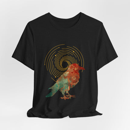 Raven dreamcatcher boho graphic with golden celestial rings and teal textured artwork on a black t-shirt.