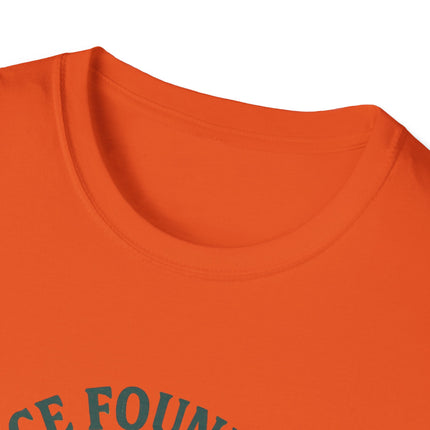 Close-up of a tagless orange shirt with text on a white background