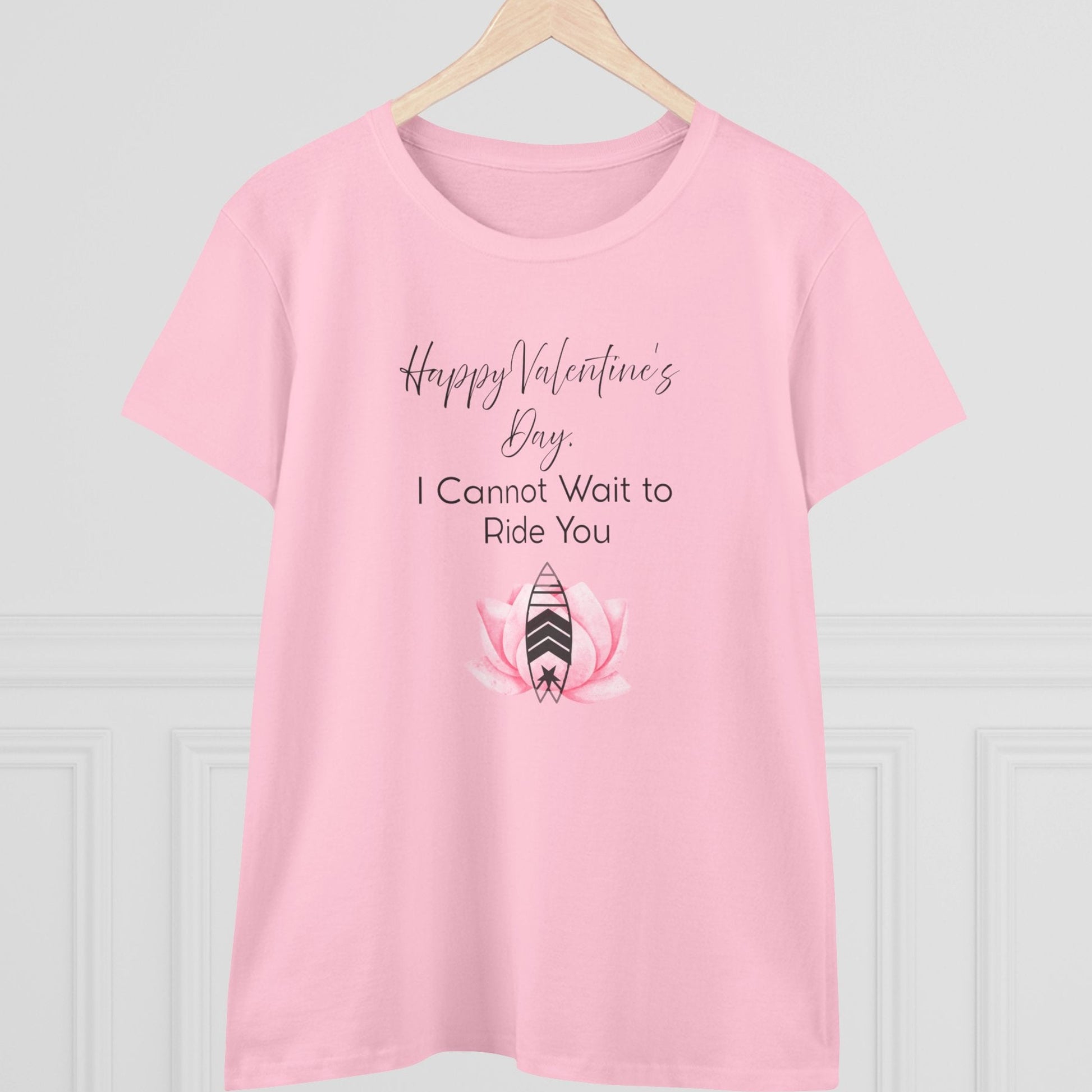 Pink t-shirt with Valentine's Day text and graphic on a hanger against a light gray background