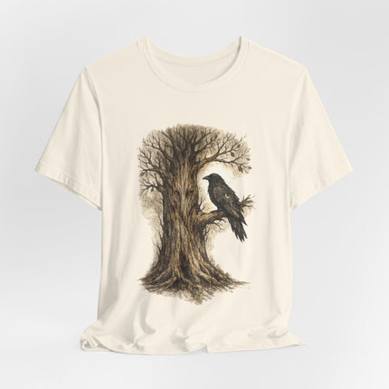 Beige t-shirt with a tree and crow design on a light gray background