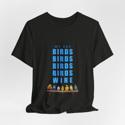 A black short-sleeve t-shirt with a graphic print on the front. The graphic features the text 'MY DAY BIRDS BIRDS BIRDS BIRDS WINE' in blue, with a row of colorful birds perched on a branch at the bottom.