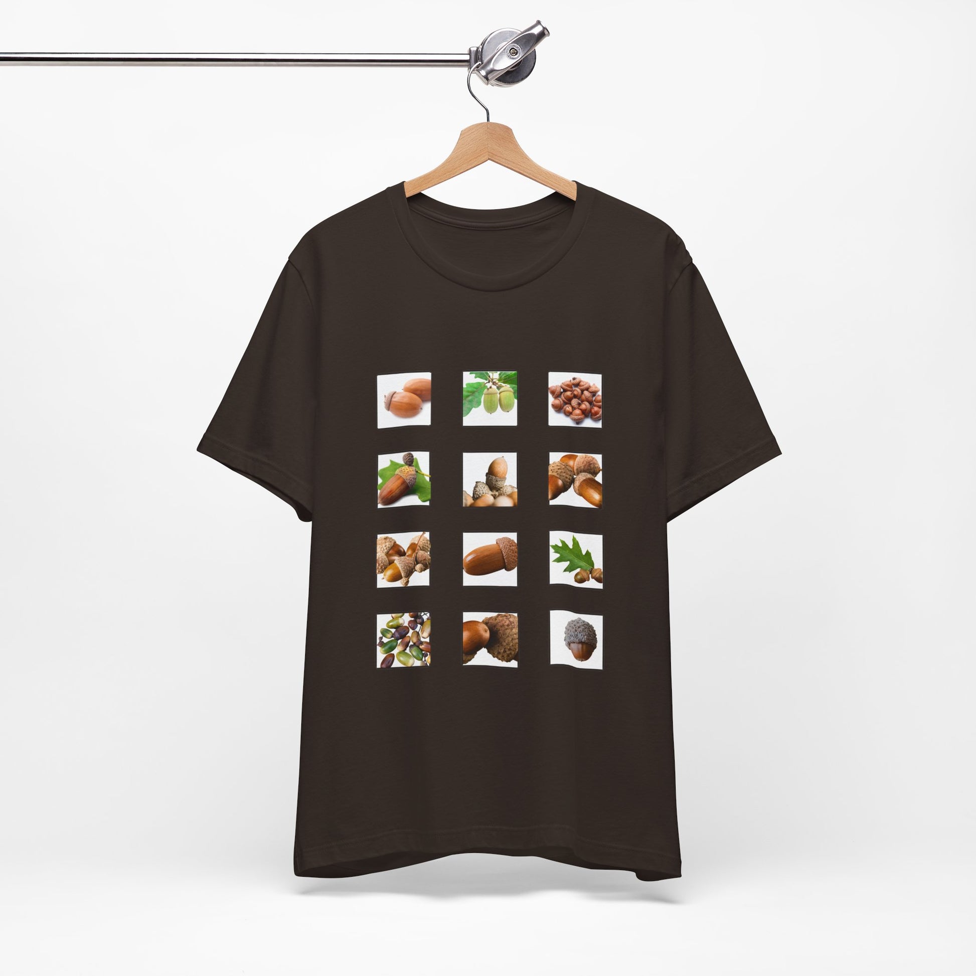 Brown t-shirt with postage stamp  images of acorns items on a hanger against a white background