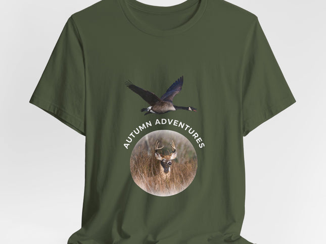 An olive green short-sleeve t-shirt with a graphic print on the front showing a flying goose above a circular deer head with the text 'AUTUMN ADVENTURES'.