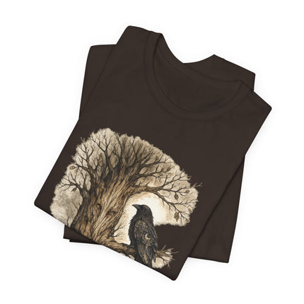 Folded brown t-shirt with a tree and bird design on a white background