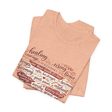 Folded peach-colored tank top with motivational text design on a white background