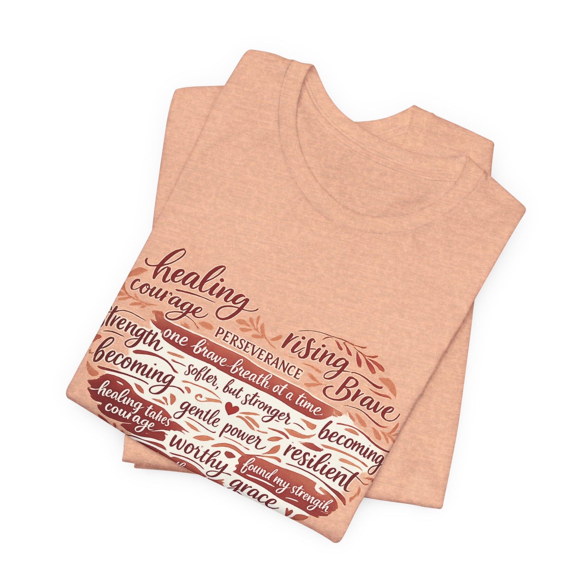Folded peach-colored tank top with motivational text design on a white background