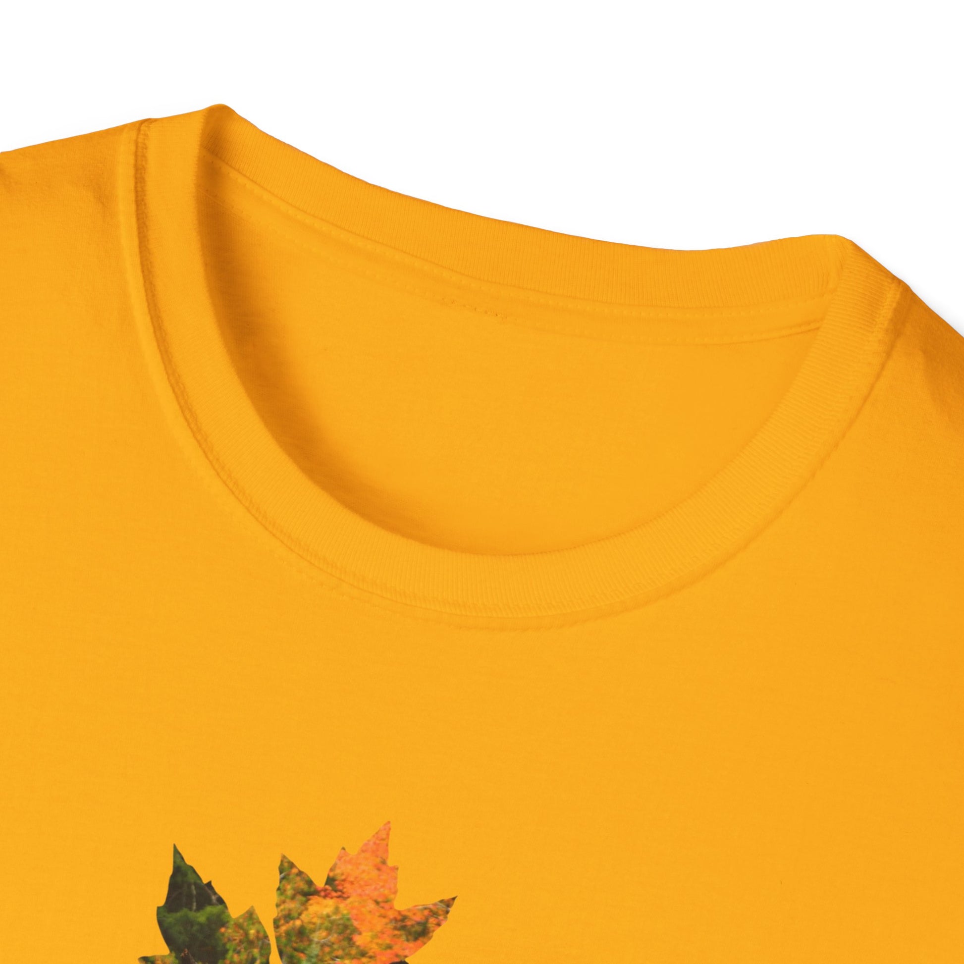 Close-up neckline of a yellow shirt with autumn leaf design on a white background