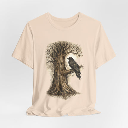 Beige t-shirt with a tree and crow design on a light gray background