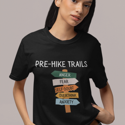 Person wearing a black t-shirt with 'Pre-Hike Trails' graphic design.