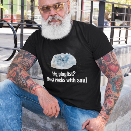 Man with tattoos and sunglasses wearing a black t-shirt with a graphic and text.