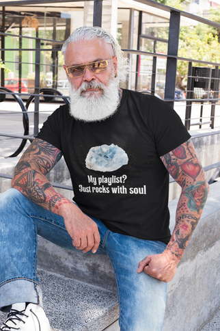 Man with tattoos and sunglasses wearing a black t-shirt with a graphic and text.