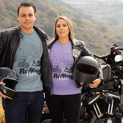 Two people standing next to a motorcycle with a scenic background