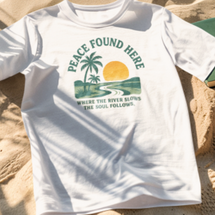 White t-shirt with a graphic design on a sandy surface