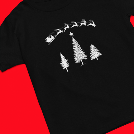 A black short-sleeve t-shirt with a white graphic print of Santa Claus's sleigh and three Christmas trees, laid flat on a solid red background.