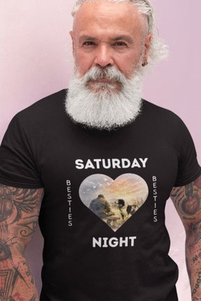 A man with a white beard and tattoos wearing a black t-shirt with a graphic that reads 'SATURDAY Night' and 'BESTIES' vertically, featuring a heart-shaped photo print in the center.